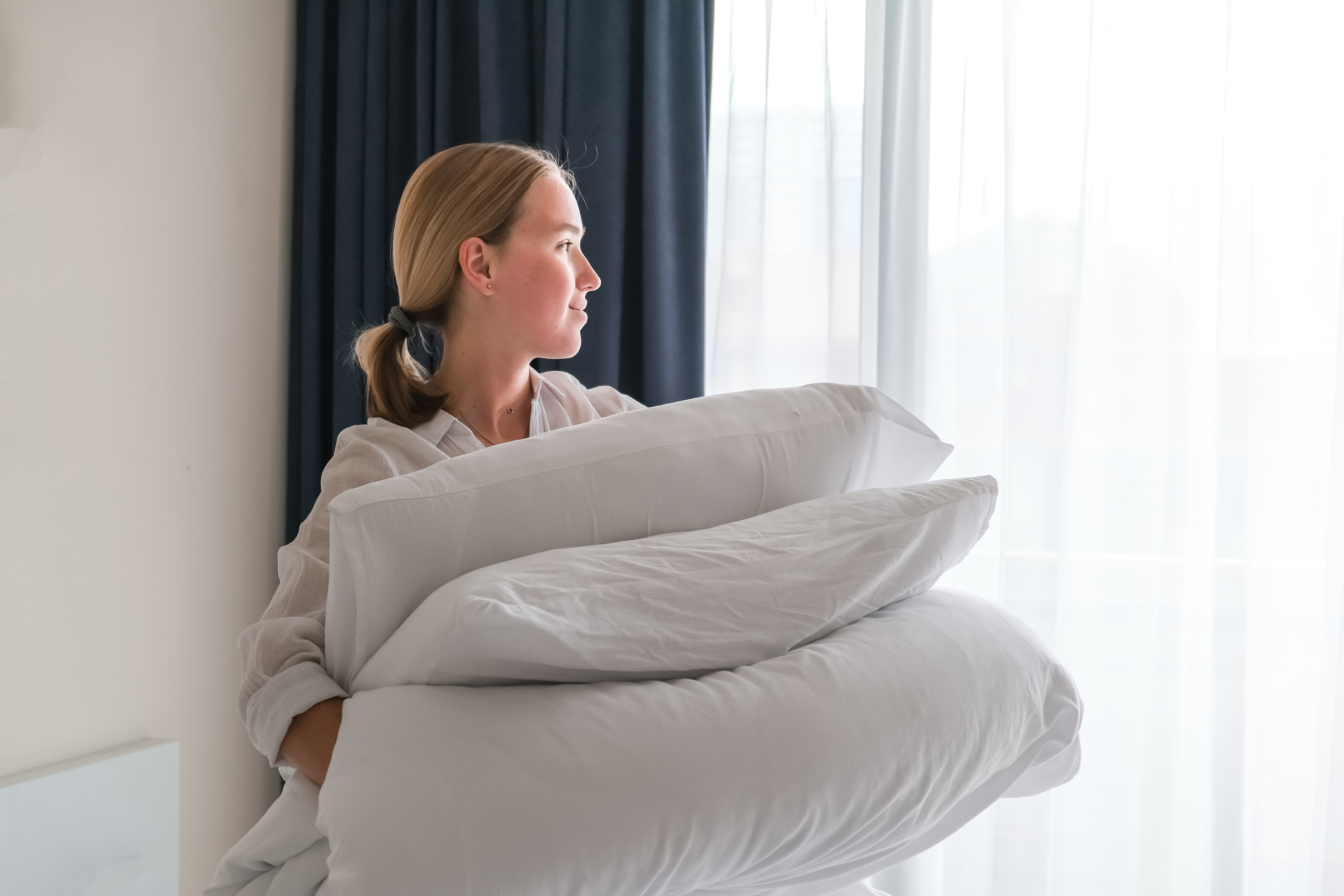 girl cleans the bedroom. Makes the bed after sleep. House cleaning, daily cleaning concept, cleaning